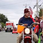 Bob Heflin, a Juneau-Douglas Shrine Club member, hands out candy on his mini motorcycle Tuesday afternoon during the annual Fourth of July parade in Douglas. (Clarise Larson / Juneau Empire)