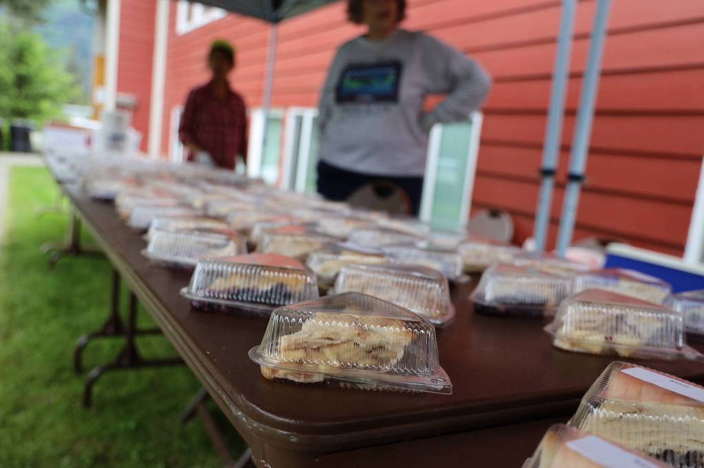 Pieces of homemade pies line tables in front of Douglas Community United Methodist Church for its annual fundraiser Tuesday afternoon before the start of the annual Fourth of July parade in Douglas. (Clarise Larson / Juneau Empire)