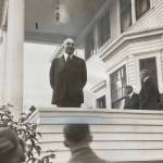 President Warren G. Harding speaks to a rain-drenched crowd from the porch of the Governors House on Calhoun Avenue on July 10, 1923. He was accompanied on his Voyage of Understanding by several cabinet members including Secretary of Commerce Herbert Hoover, whose profile is seen clearly in the background. Harding was the countrys 29th president. Hoover was elected the 31st. (Alaska State Library Historical Collection P418-2.)