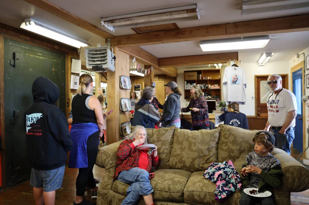 Residents gather for a potluck Monday afternoon to celebrate the grand opening of Pelican General, the towns first general store to open in 15 years. (Clarise Larson / Juneau Empire)