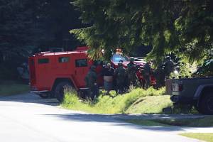 Andre P. Lawrence is detained by police officers at a residence on Riverwood Drive on Friday morning. He was later arrested in connection with the fatal shooting of a 23-year-old man on Cinema Drive on Thursday evening. (Clarise Larson / Juneau Empire)