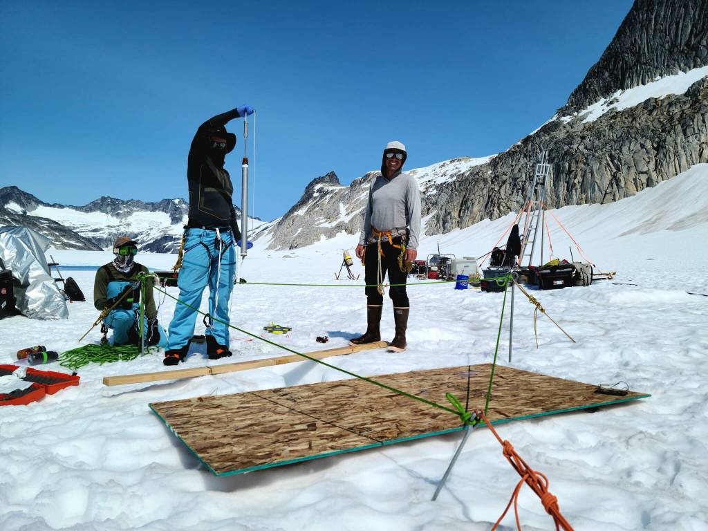 Scientists Jake Shaffer and Jared Clance, along with field mountaineer Brian Muller, collect water samples from an air-water interface on the Juneau Icefield earlier this month. Researchers are studying the bottom of the water table at bedrock  272 meters down  and doing a biochemical analysis for elements such as major ions, dissolved organic carbon and biomolecules. Such data may provide links about connections between the top and bottom of the water table. (Photo courtesy of Jacob Holmes)