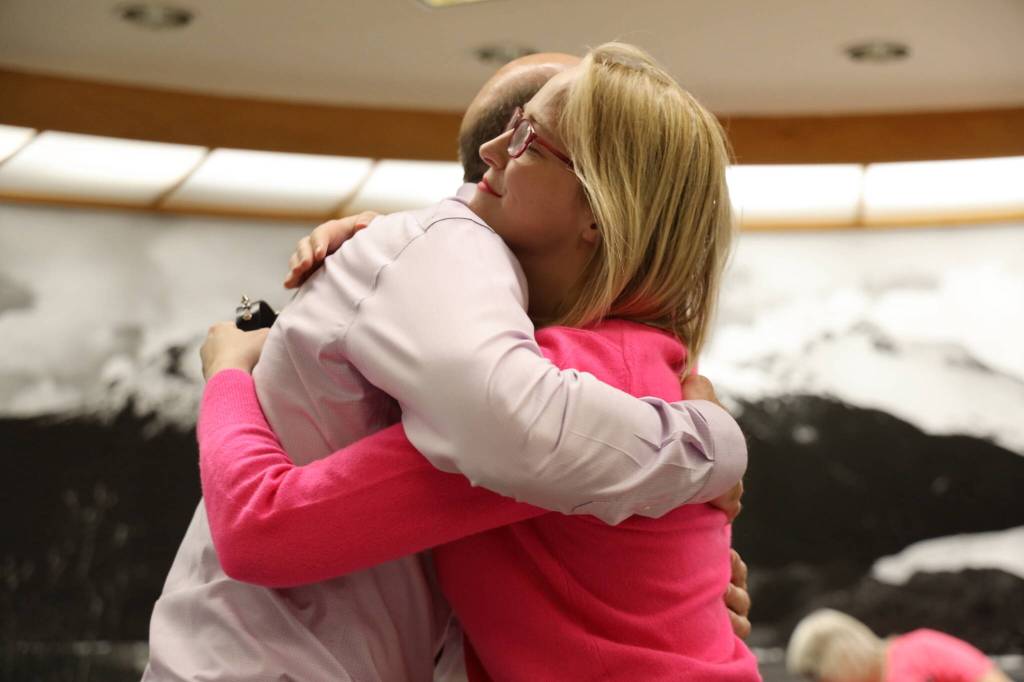 City and Borough of Juneau Assembly member Carole Triem and Deputy City Manager Robert Barr share a hug during the Assembly meeting Monday night. The meeting was Triems last time serving as a member as she departs from her role for family medical issues. (Clarise Larson / Juneau Empire)