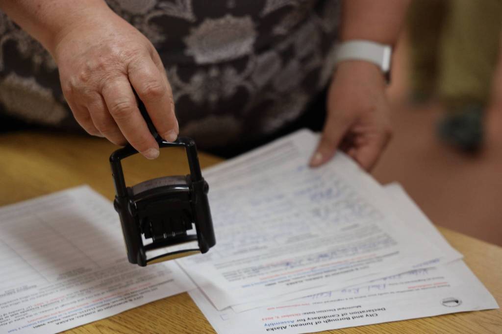 City and Borough of Juneau Clerk Beth McEwen certifies areawide candidate Paul Kellys paperwork Friday morning within minutes of the local election filing period opening. Kelly is running for one of the two areawide Assembly positions open. (Clarise Larson / Juneau Empire)