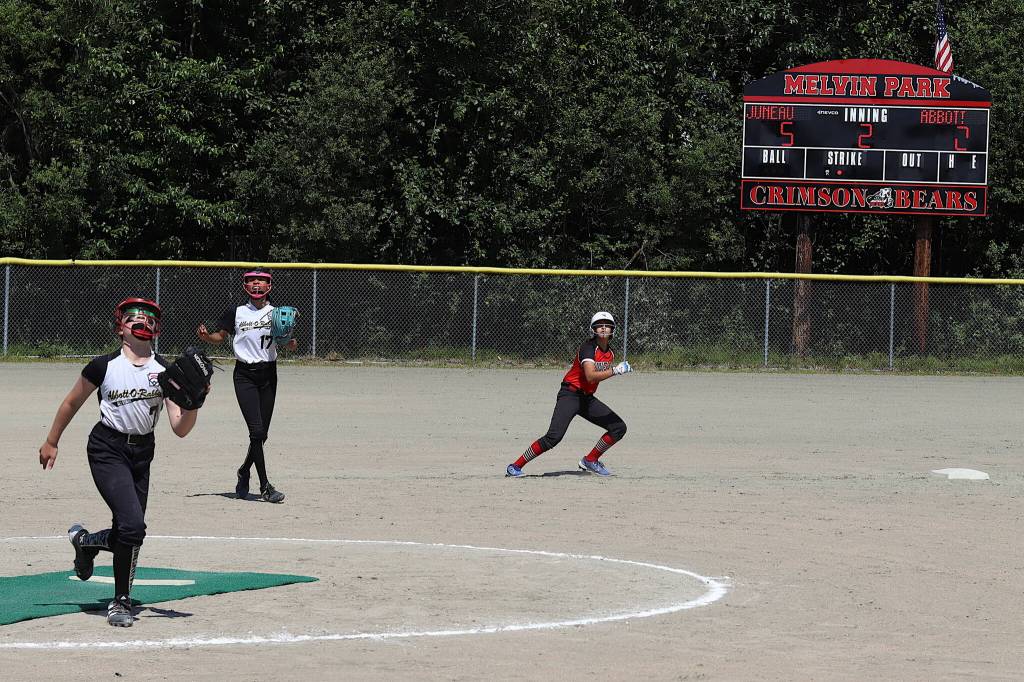 Gia Walker (17) and Charlotte Nelson (7) try to make a play on a fly ball as Katelyn Sulser retreats to second base during the second inning of a game against Anchorages Abbot-O-Rabbit Saturday at Marvin Park as part of the Majors Softball State Tournament. Sulser and two other Juneau players would go on to score before the end of the inning, giving Juneau a 7-2 lead. (Mark Sabbatini / Juneau Empire)