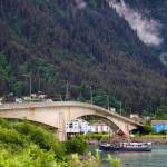 A boat passes under the Juneau-Douglas Bridge in late June. A person reportedly jumped off the bridge managed to make it to Overstreet Park on Saturday evening, according to the Juneau Police Department. (Clarise Larson / Juneau Empire File)
