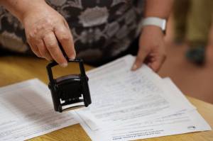 Clarise Larson / Juneau Empire File
City and Borough of Juneau Clerk Beth McEwen certifies areawide candidate Paul Kellys paperwork Friday morning within minutes of the local election filing period opening. Kelly is running for one of the two areawide Assembly positions open.