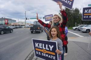 Kelly Tshibaka waves at passing motorists in Midtown Anchorage on Aug. 16, 2022. The former U.S. Senate candidate, now head of a nonprofit opposing ranked choice voting, is the subject of a new campaign complaint. (Photo by Yereth Rosen/Alaska Beacon)