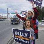 Kelly Tshibaka waves at passing motorists in Midtown Anchorage on Aug. 16, 2022. The former U.S. Senate candidate, now head of a nonprofit opposing ranked choice voting, is the subject of a new campaign complaint. (Photo by Yereth Rosen/Alaska Beacon)