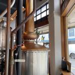 Amalga Distillerys Kentucky-built pot still stands below an original Art Deco pillars decorative feature inside historic AELPs 1930s concrete building. (Photo by Laurie Craig)