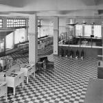 Alaska Electric Light and Power Companys 1937 showroom displays new labor-saving electric appliances such as cooking ranges, vacuum cleaners, lamps, toasters, irons, and wringer washing machines. The building is located at Second and Franklin Streets. Over the years, many different businesses have occupied the concrete building. Today, it is the home of Amalga Distillery. (Photo courtesy AELP)