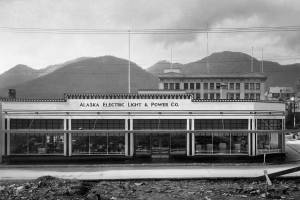 The Franklin Street view of AELPs 1930s building reveals its Art Deco architectural style, characterized by geometric features. The power companys name is recessed in cast concrete. N. Lester Troast Co. designed the building which R. J. Somers constructed. The five-story Goldstein Emporium rises in the background with Douglas Island hills beyond. (Photo courtesy AELP)