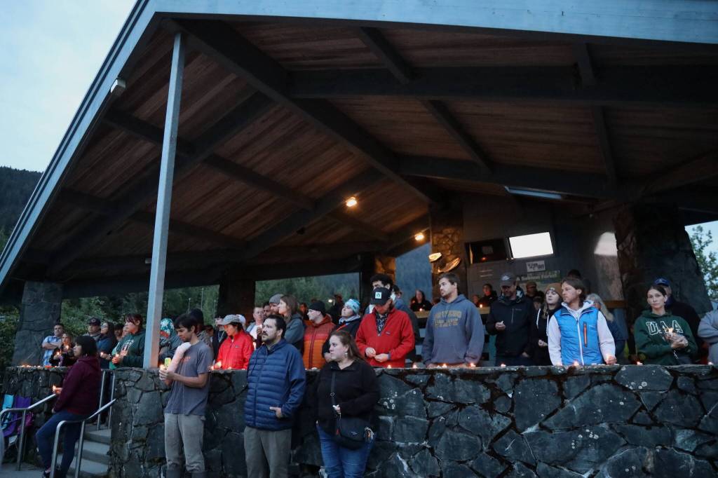 Dozens of residents gathered Wednesday night at a pavilion at the Mendenhall Glacier Visitor Center to honor Paul Rodriguez Jr. who drowned while kayaking on Mendenhall Lake last week. (Clarise Larson / Juneau Empire)
