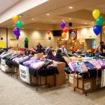 A total of 1,200 backpacks for students of all ages are stacked on and under tables at Elizabeth Peratrovich Hall.