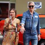 Cordova Pleasants, founder of Alaska Fashion Week and owner of Resolute Boutique in Juneau, tells a runway show audience about jewelry made and being worn by Jackie Kragel, one of the models in Saturdays show. (Mark Sabbatini / Juneau Empire)