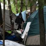 Tents fill a homeless camp near Davis Park in Mountain View on July 3 in Anchorage. An unfunded proposal by Anchorages mayor to pay for plane tickets to warmer climates for homeless people who would otherwise be forced to winter outside in the bitter cold has caused a stir in Alaskas biggest city. If the program moves forward, people can choose to relocate to the Lower 48 or somewhere else in Alaska where it might be warmer or where they have relatives. (Bill Roth / AP)