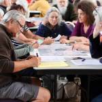 Mark Whitman, a Douglas resident, joins others in offering opinions about the future of Telephone Hill during an open house at the Juneau Arts and Culture Center on Wednesday. (Mark Sabbatini / Juneau Empire)