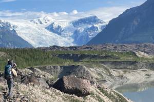 From left, Martin Truffer and Adam Bucki walk along the gravel moraine of Kennicott Glacier on an 11-hour hike to reach Fireweed rock glacier. (Photo by Ned Rozell)