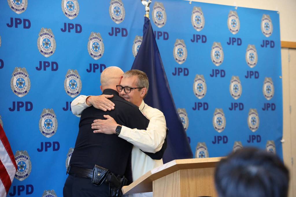 Retiring Juneau Chief of Police Ed Mercer (left) and City Manager Rorie Watt (right) hug during Mercers retirement ceremony Friday afternoon at the Juneau Police Department station. (Clarise Larson / Juneau Empire)
