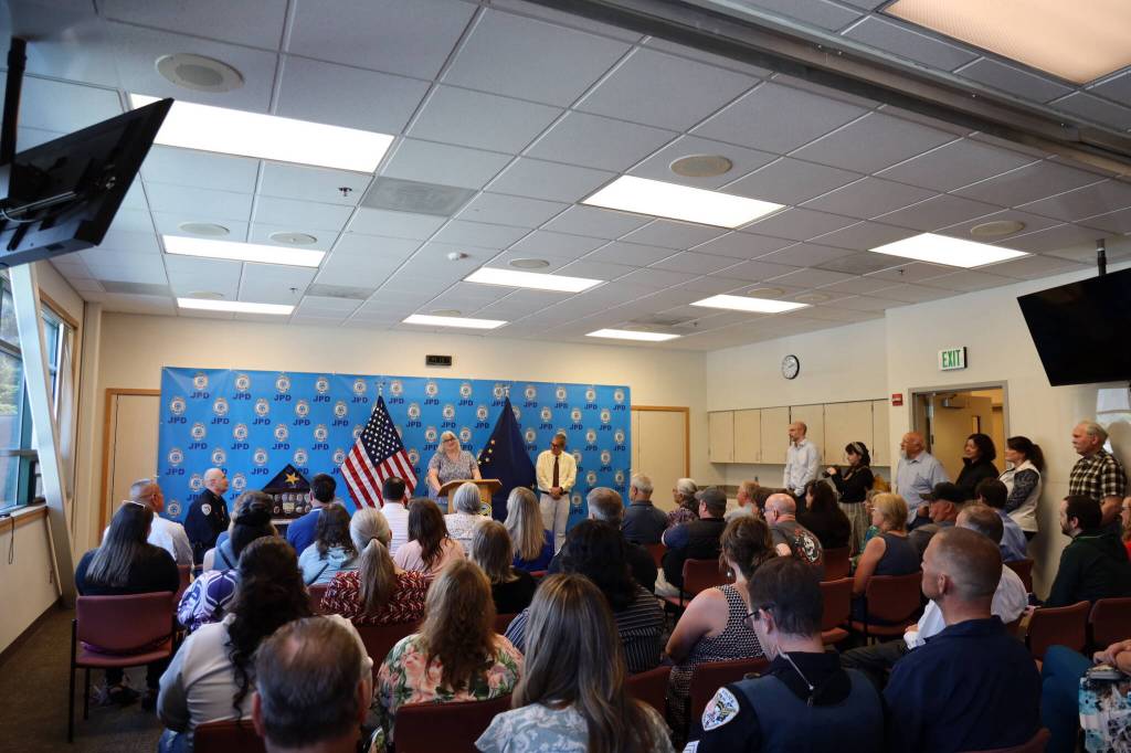 Dozens of of law enforcement personnel, family members and city officials listen to speeches given to commemorate Juneau Chief of Police Ed Mercers retirement during a ceremony Friday afternoon at the Juneau Police Department station. (Clarise Larson / Juneau Empire)