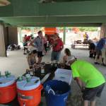 Participants in the Juneau Marathon and Half Marathon take shelter from the sun as they recharge with food and drinks at Savikko Park on Saturday. (Photo courtesy of Juneau Trail and Road Runners)