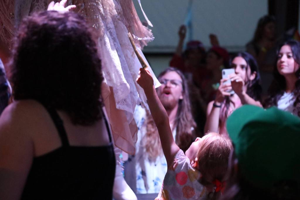 A young audience member hands a Juneau Drag performer a cash tip mid performance at the main stage of the Southeast Alaska State Fair in Haines on Friday evening for the performance groups debut show at the fair. (Clarise Larson / Juneau Empire)