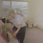 Marie Darlin unpacks her record collection as she moves into her fifth-floor apartment in Fireweed Place. (Brian Wallace / Juneau Empire Archives)