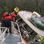 U.S. Coast Guard personnel conducts a rescue of a man aboard a commercial fishing vessel that began taking on water in Gastineau Channel Tuesday morning. (Courtesy / Coast Guard Sector Southeast Alaska)