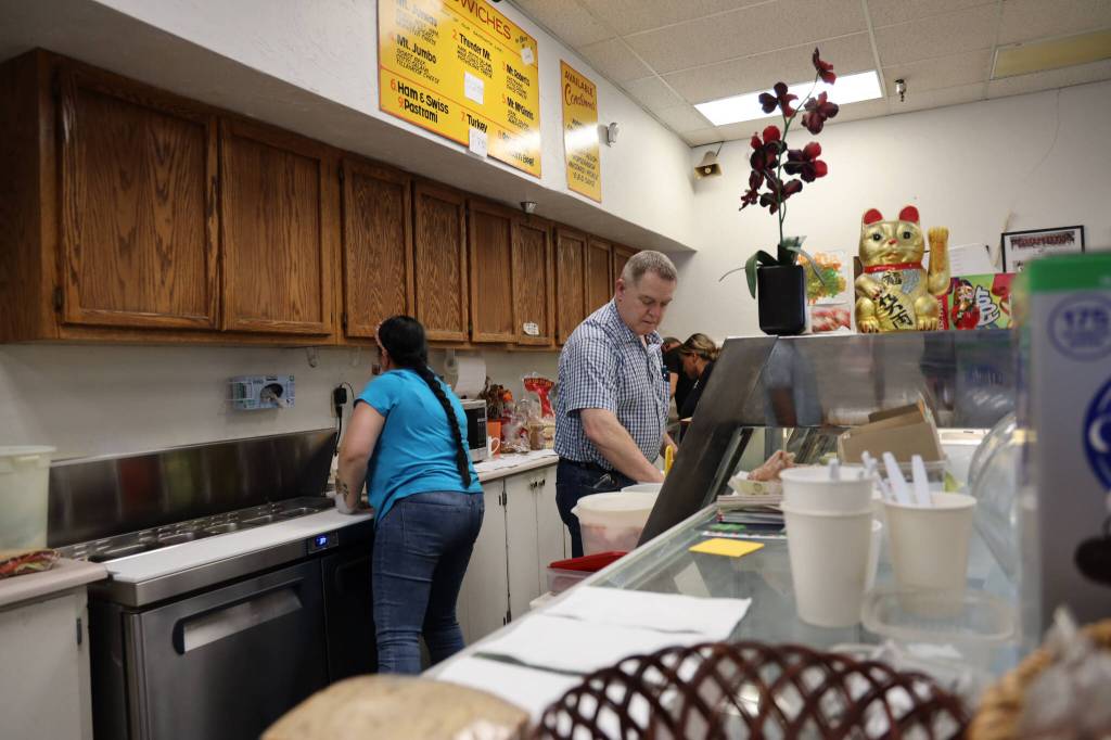 Alma Doogan prepares a sandwich at J&J Deli and Asian Mart for the last time on Monday. (Clarise Larson / Juneau Empire)