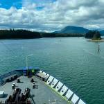 Ordinary Seaman Ann Griswold stands lookout on the foredeck of Columbia as it makes its way through the Wrangell Narrows. (Meredith Jordan / Juneau Empire)