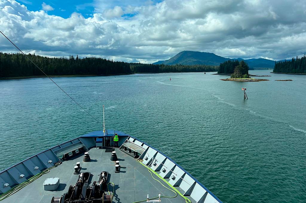 Ordinary Seaman Ann Griswold stands lookout on the foredeck of Columbia as it makes its way through the Wrangell Narrows. (Meredith Jordan / Juneau Empire)