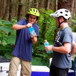 Bay White (left) and Reid Graham, both 13, take a break while volunteering to work on the nearly completed Thunder Mountain Bike Park on Saturday. Both said they are experienced riders who frequent other mountain bike trails in Juneau. (Mark Sabbatini / Juneau Empire)