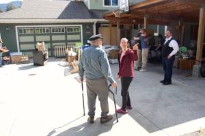 Amanda Arra (right) explains her plans for evacuating her home to Ric Iannolino at midday Sunday after a record flood Saturday eroded about 50 feet of her backyard and a quarter of the earth under her house. Dozens of local residents are facing the losses of their residences due to erosion and other damage that they say is beyond repair. (Mark Sabbatini / Juneau Empire)