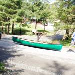 A man hauls a canoe down View Drive on Sunday, a day after residents used various boats to shuttle to and from homes that were cut off from road access to the rest of Juneau by record flooding from Suicide Basin. (Mark Sabbatini / Juneau Empire)