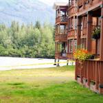 Part of a condominium complex hangs over an eroded embankment along the Mendenhall River on Sunday. Two buildings in the complex were evacuated on Saturday due to record flooding from Suicide Basin. (Mark Sabbatini / Juneau Empire)
