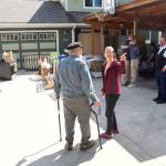 Amanda Arra (right) explains her plans for evacuating her home to Ric Iannolino at midday Sunday after a record flood Saturday eroded about 50 feet of her backyard and a quarter of the earth under her house. Dozens of local residents are facing the losses of their residences due to erosion and other damage that they say is beyond repair. (Mark Sabbatini / Juneau Empire)