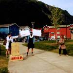 Natalia Spengler points to data on signs held up by Conor Lendrum as Ellie Pisel-Davis describes the significance of the data during the annual Climate Fair for a Cooler Planet on Saturday at Overstreet Park. (Meredith Jordan / Juneau Empire)