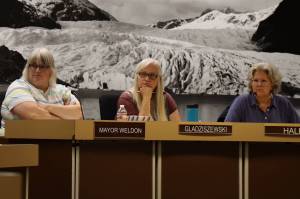 City and Borough of Juneau Mayor Beth Weldon (far left), Deputy Mayor Maria Gladziszewski (middle) and Assembly member Michelle Bonnet Hale listen during a special Assembly meeting Monday night where members OKd a resolution to seek state and federal funding following record flooding over the weekend. (Clarise Larson / Juneau Empire)
