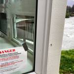 A sign marks a house along the Mendenhall River that is condemned following a glacial dam outburst Saturday that resulted in weekend flooding along the river. (AP Photo/Becky Bohrer)