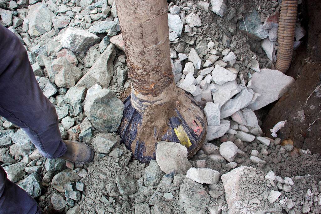 A support post of a residential building at Riverside Condominiums rests on a new bed of rock fill Wednesday after it was exposed due to erosion from record flooding of the Mendenhall River on Saturday. (Mark Sabbatini / Juneau Empire)