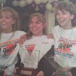 Assistant drill team coach Evonne Noonan, left, drill team captain Jennifer Fredrick and drill team coach Leslie Dahl pose photographs after arriving at the airport on Tuesday, Aug. 9, 1995. The drill team was greeted by a crowd of about 400 people. (Brian Wallace / Juneau Empire Archives)