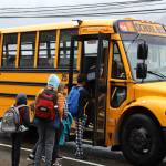 Students enter a bus stopped on Douglas Highway Tuesday morning for the first day of the 2023-2024 school year. (Clarise Larson / Juneau Empire)