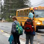Students await their bus on Douglas Highway Tuesday morning for the first day of the 2023-2024 school year. (Clarise Larson / Juneau Empire)
