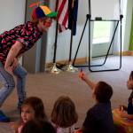 Evan Handsome, a Juneau Drag performer, shares noisemakers with kids during a Drag Storytime at the Mendenhall Valley Public Library Saturday, Aug. 5. (Mark Sabbatini / Juneau Empire)