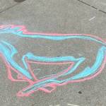 Racing along the waterfront… chalk drawing at the Goldbelt Tram on Aug. 3. (Photo by Denise Carroll)