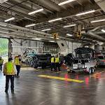 Workers load cars aboard the Columbia ferry during a stop in mid-July. (Meredith Jordan / Juneau Empire)