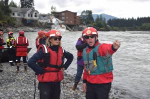 U.S. Sen. Lisa Murkowski (left) views the Mendenhall River on Tuesday as Juneau Assembly member Wade Bryson explains changes that occurred to the riverbank due to record flooding from Suicide Basin last Saturday. Juneau state representatives Sara Hannan and Andi Story were among the other officials taking part in the trip. (Tom Mattice / City and Borough Of Juneau)