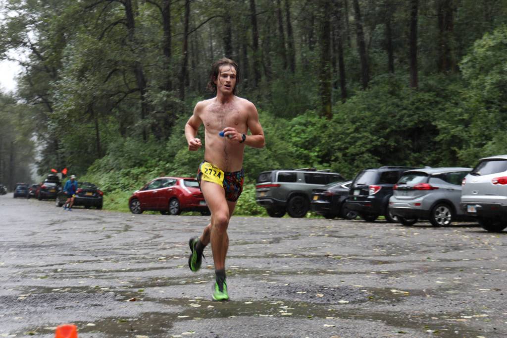 Clem Taylor-Roth a Juneau resident, sprints to the finish line to win the Nifty Fifty 25K race Saturday afternoon with a time of 2 hours, 25 minutes and 17 seconds. (Clarise Larson / Juneau Empire)