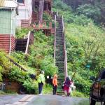 An American Red Cross worker (in orange) advises people evacuating belongings from a house on Nelson Street following a small landslide Saturday evening. City officials ordered the evacuation of homes near the slide, and issued a notice asking people to stay away from the landslide area and for people in high-slope areas to be aware of landslide risks due to heavy rain. (Mark Sabbatini / Juneau Empire)