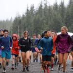 Senior captains Edgar Vera and Etta Eller lead the Juneau-Douglas Yadaa.at Kalé High School cross-country team in a warmup jog during a rainy day practice near the Mendenhall Glacier Visitors Center on Monday. (Clarise Larson / Juneau Empire)